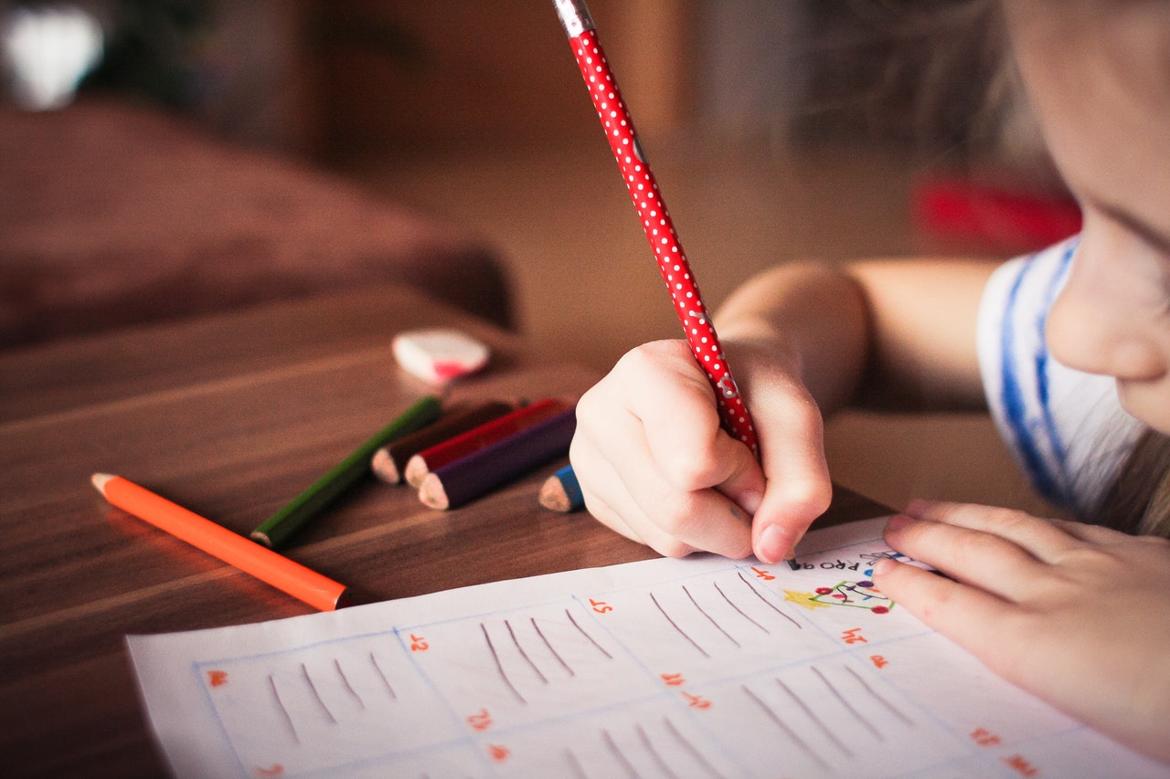 child completing an activity sheet